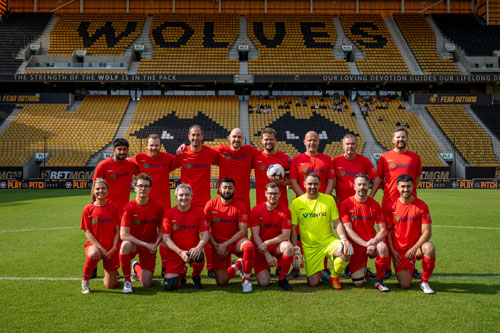 Tecman charity football match group shot red team